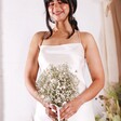 A model shot of a bride holding the posy