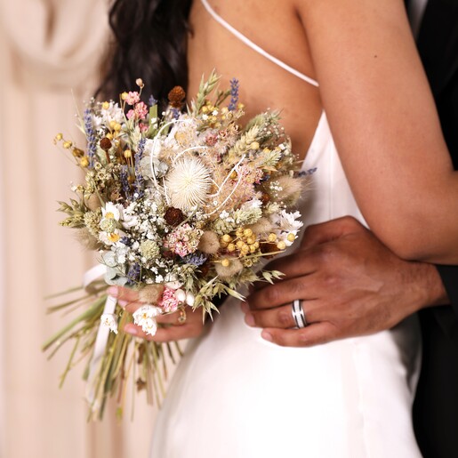 A close up of a model holding the posy