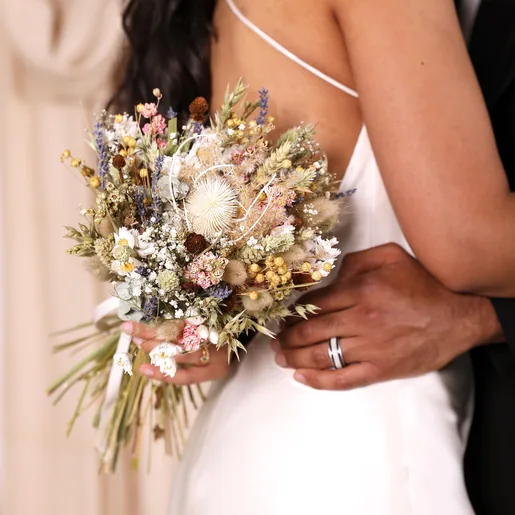 A close up of a model holding the posy
