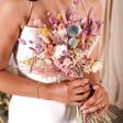 A close up of the model holding a posy