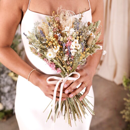 A close up of a model holding the posy