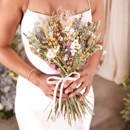 A close up of a model holding the posy