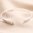 Close up of ends on Always in My Thoughts Meaningful Word Bangle in Silver against beige material