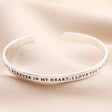 Other side of quote on Always in My Thoughts Meaningful Word Bangle in Silver against neutral fabric