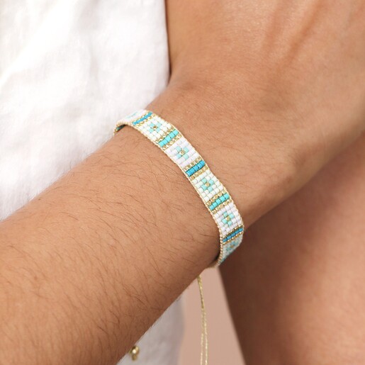 Blue Beaded Woven Cord Bracelet in Gold on model with hand on arm