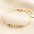 Blue Ombre Crystal Star Bar Bracelet in Gold on top of beige coloured fabric