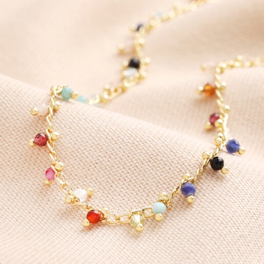 Colourful Semi-Precious Stone Tiny Droplet Necklace in Gold on Beige Background