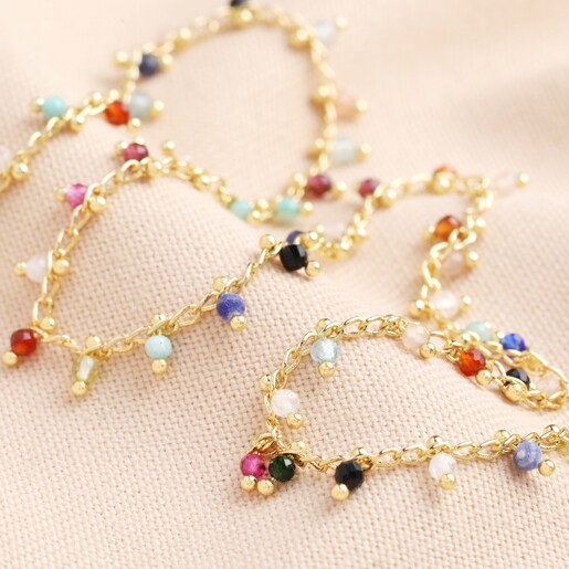 Colourful Semi-Precious Stone Tiny Droplet Necklace in Gold on Beige Background