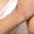 close up of the  Dainty Flower Charm Bracelet in Silver on model