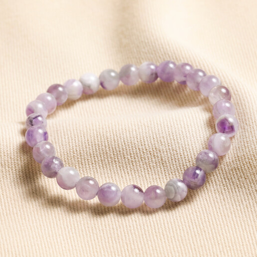 February amethyst Birthstone Semi-Precious Stone Beaded Bracelet against neutral backdrop