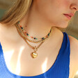 Close Up Gold Stainless Steel Chunky Toggle and Heart Pendant Necklace on Model Layered with Other Jewellery Pieces