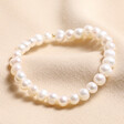 June pearl Birthstone Semi-Precious Stone Beaded Bracelet on top of beige fabric