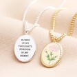Back of Meaningful Word Enamel Flower Pendant Necklace in Silver next to front of gold version on neutral coloured material