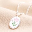 Meaningful Word Enamel Flower Pendant Necklace in Silver on top of beige coloured backdrop