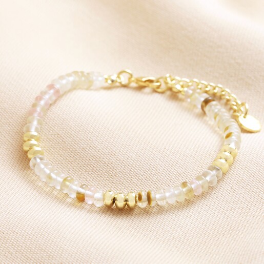 Mixed Rondelle Stone Beaded Bracelet in Gold laid on top of neutral coloured fabric