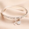 Moon and Sun Meaningful Word Bangle in Silver on top of beige coloured fabric
