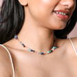 Multicoloured Semi-Precious Stone Chip Necklace in Gold on model with dark hair in front of neutral backdrop