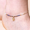 Close up of Blue Miyuki Bead Turtle Charm Cord Anklet in Gold on model