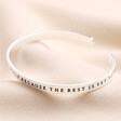 Other side of A New Chapter Meaningful Word Bangle in Silver against neutral background