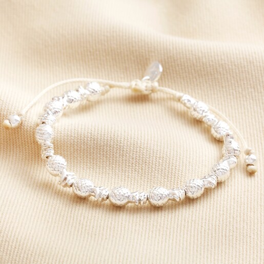 Pineapple Charm Beaded Bracelet in Silver on top of beige coloured fabric