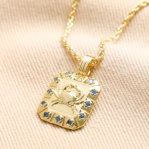 Cancer Crystal Square Zodiac Pendant Necklace in Gold on Neutral Fabric Cancer Crystal Square Zodiac Pendant Necklace in Gold