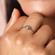 Close up of the Stainless Steel Crystal Eye Ring on a model's middle finger