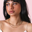 Necklace on model with black hair in front of neutral coloured backdrop