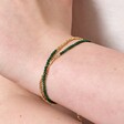 Close Up of Green Semi-Precious Stone Layered Beaded Bracelet in Gold on Model