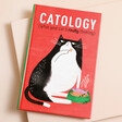 Catology Book on top of beige coloured background