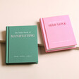 The Little Book of Manifesting and The Little Book of Self-Love on Beige Surface