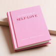 The Little Book of Self Love on Beige Surface
