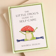 The Little Frog's Guide to Self Care Book on Beige Surface