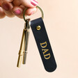 Dad Personalised Name Leather Keyring in navy on keys held against beige backdrop