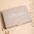 Personalised Stackers Classic Jewellery Box in Taupe against beige backdrop with jewellery outside