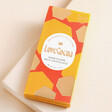 Love Cocoa Mini Honeycomb 41% Milk Chocolate Bar on top of raised beige surface
