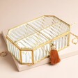 Large Ribbed Glass Jewellery Box in Gold against Beige Background