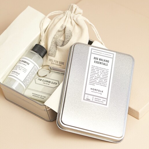 Norfolk Natural Living Dog Walking Kit with products inside of tin against beige coloured background