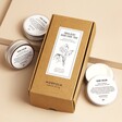 Norfolk Natural Living Set of 3 Hand Creams with hand creams outside of packaging against beige coloured background