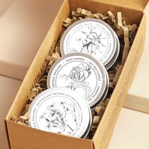 Norfolk Natural Living Set of 3 Mini Candles open inside of packaging against beige backdrop