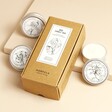 Norfolk Natural Living Set of 3 Mini Candles with candles outside of packaging against beige backdrop