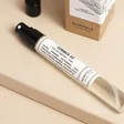 Close up of bottle from Norfolk Natural Living 93 Days of Summer Parfum outside of packaging against neutral coloured backdrop