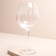 Personalised Engraved Wildflower Balloon Gin Glass against beige coloured background