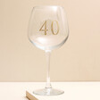 Personalised Gold Milestone Birthday Gin Glass against beige backdrop