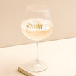 Personalised Gold Name and Constellation Gin Glass standing on top of beige coloured backdrop