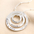 Close up of personalisation on Personalised Sterling Silver Hammered Halo Necklace against neutral fabric