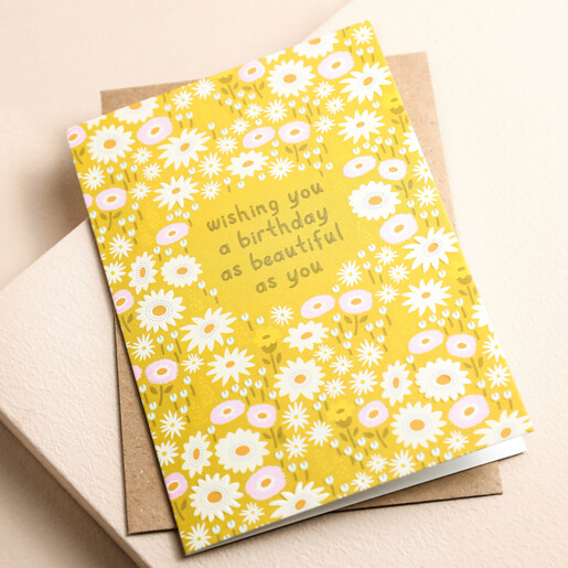 Ohh Deer Yellow Flower Beautiful Birthday Card  on top of envelope on beige surface 