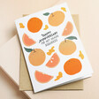 Ohh Deer Main Squeeze Oranges Anniversary Card on top of kraft envelope with beige backdrop