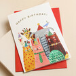 Ohh Deer Party Animals Birthday Card on top of red envelope on beige surface 