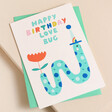 Ohh Deer Love Bug Birthday Card on top of teal envelope