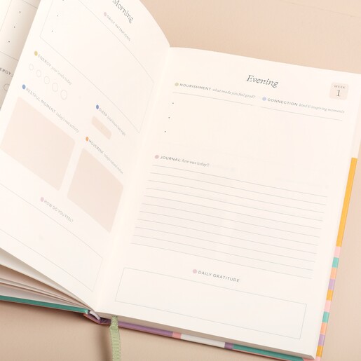 Papier Happy Stripes Wellness Journal open showing pages against beige backdrop